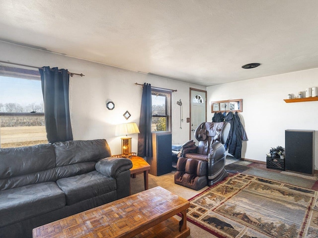 carpeted living area featuring a textured ceiling