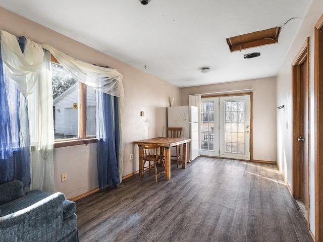 interior space with dark wood-type flooring and baseboards