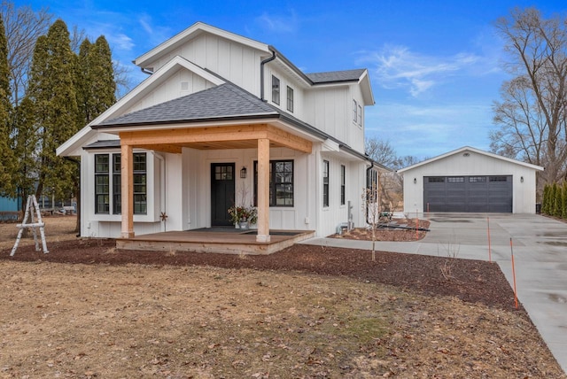 modern farmhouse style home featuring board and batten siding, a shingled roof, a detached garage, a porch, and an outdoor structure