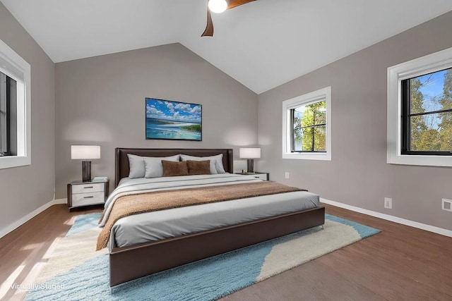 bedroom with wood finished floors, a ceiling fan, baseboards, and vaulted ceiling