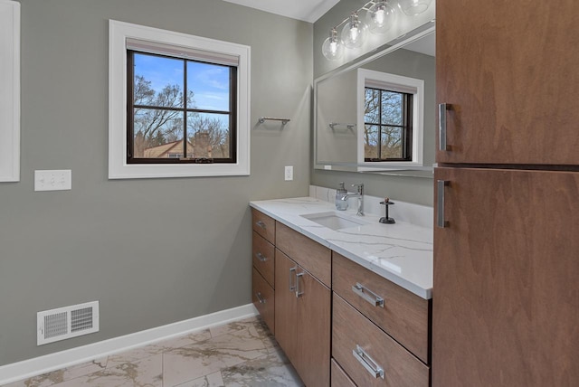 bathroom with visible vents, baseboards, marble finish floor, and vanity