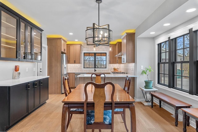 dining area featuring a notable chandelier, recessed lighting, baseboards, and light wood finished floors