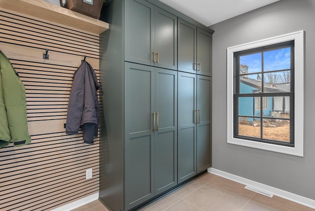 interior space with light tile patterned floors, visible vents, and baseboards