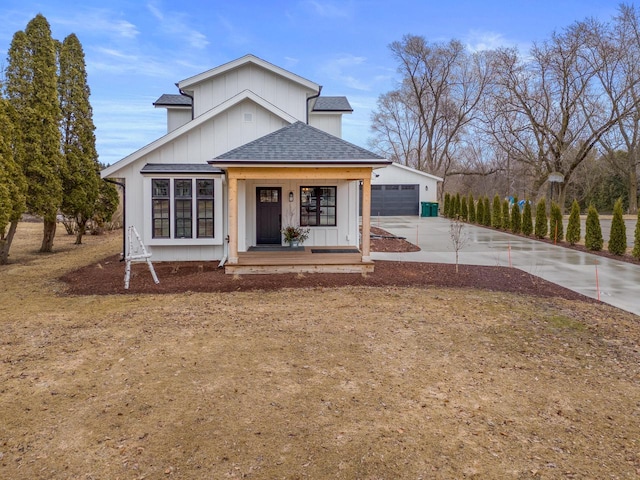 view of front of property featuring covered porch, a garage, and a shingled roof