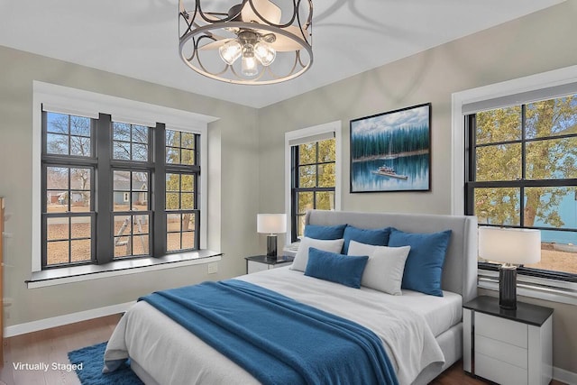 bedroom featuring wood finished floors and baseboards