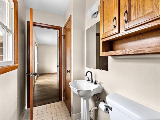 bathroom with toilet and baseboards