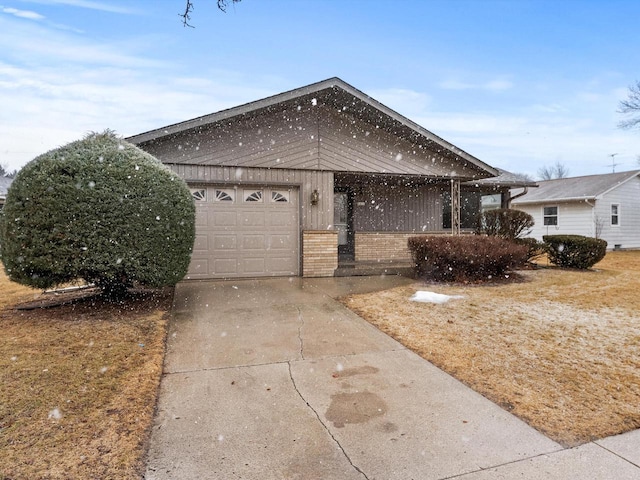 single story home with a garage, brick siding, and driveway