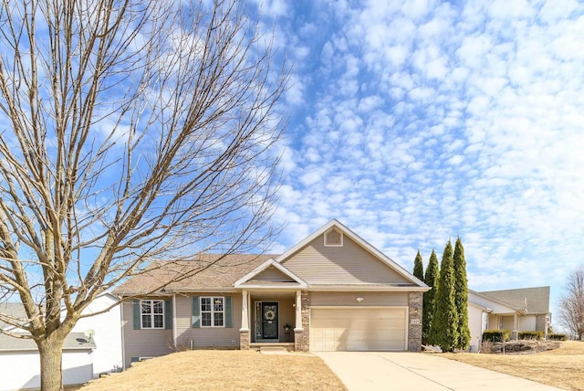 view of front of property featuring a garage, brick siding, and concrete driveway