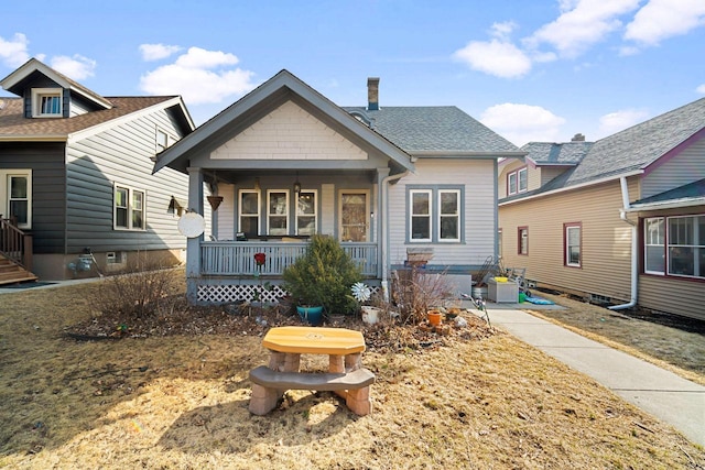 view of front of home with a porch and roof with shingles