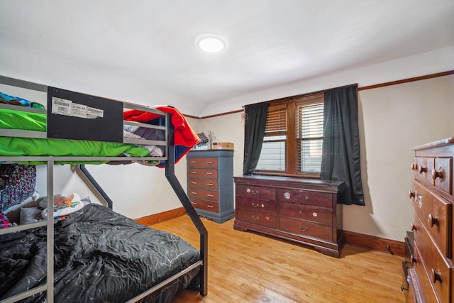 bedroom with light wood-style floors and baseboards