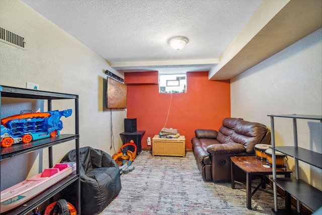 living area featuring visible vents, carpet flooring, a textured ceiling, and a textured wall