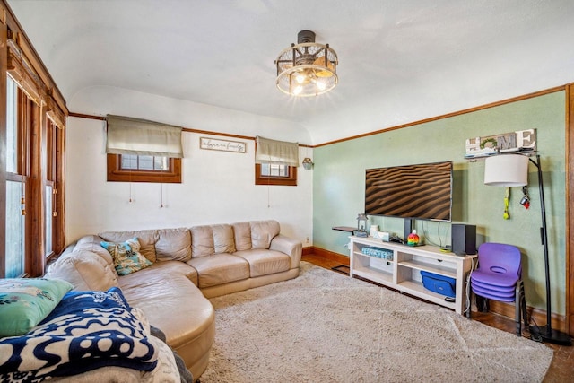 living room featuring vaulted ceiling and baseboards