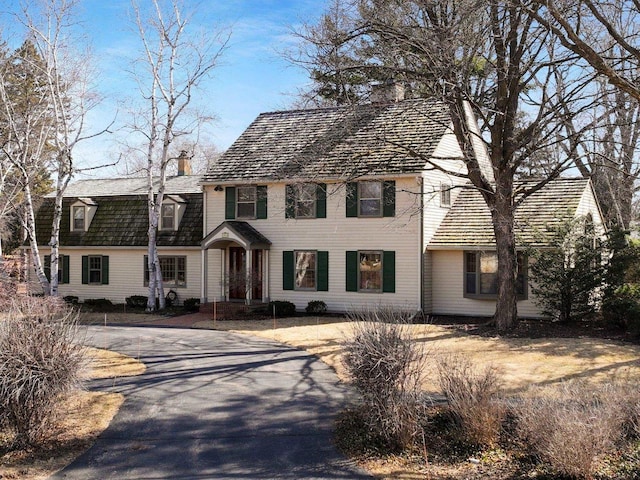 view of front of house featuring a chimney