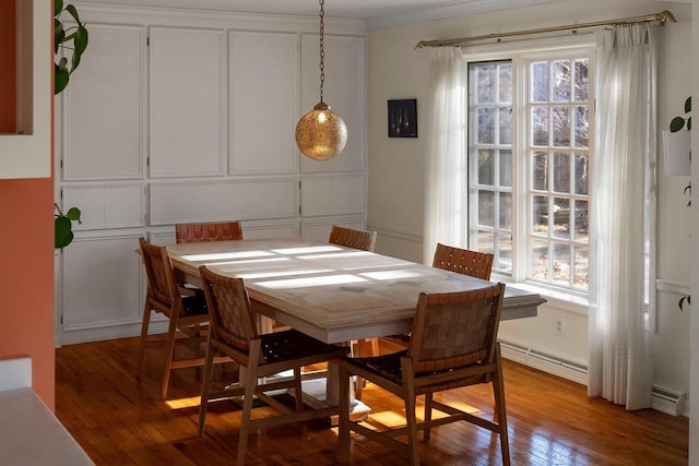 1914 Eastwood Ave, Janesville, WI 53545 - dining area with a baseboard radiator, a decorative wall, ornamental molding, and light wood finished floors