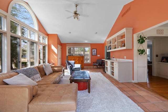 1914 Eastwood Ave, Janesville, WI 53545 - living room featuring ceiling fan, light tile patterned floors, visible vents, and high vaulted ceiling