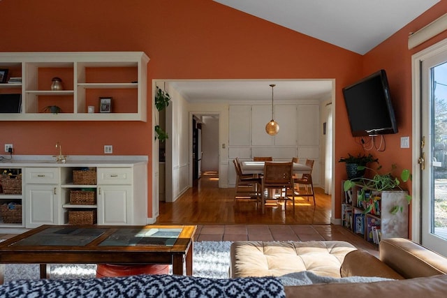 1914 Eastwood Ave, Janesville, WI 53545 - living room with a wealth of natural light, light tile patterned floors, and vaulted ceiling