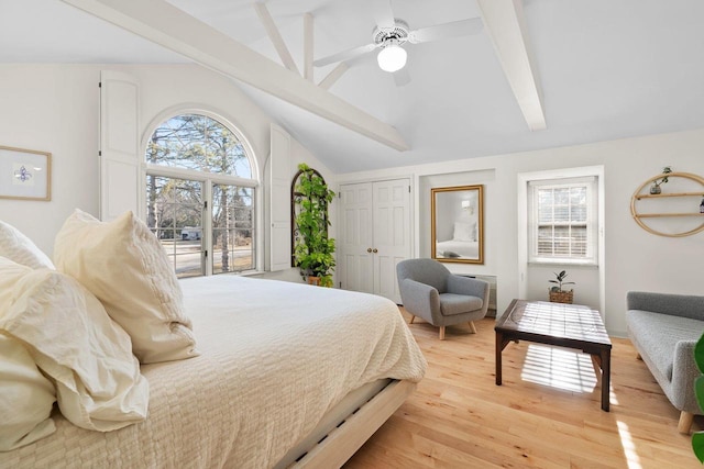 1914 Eastwood Ave, Janesville, WI 53545 - bedroom with light wood-style flooring, multiple windows, lofted ceiling with beams, and a ceiling fan