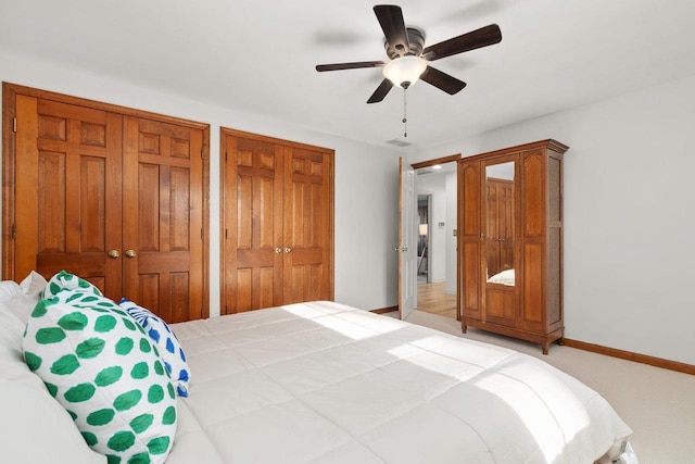 1914 Eastwood Ave, Janesville, WI 53545 - bedroom featuring visible vents, two closets, baseboards, light carpet, and a ceiling fan