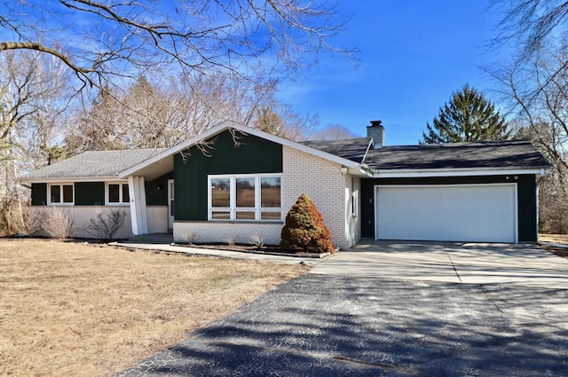 view of front facade featuring driveway, a shingled roof, a garage, brick siding, and a chimney