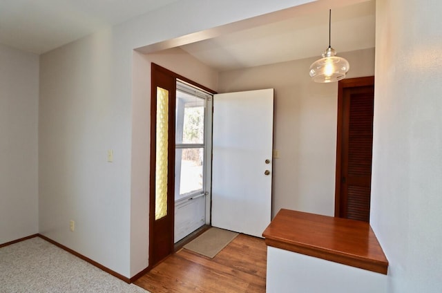 entryway with wood finished floors and baseboards