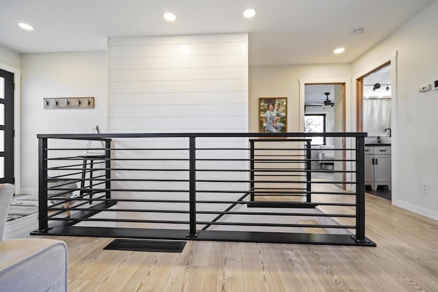 staircase featuring recessed lighting, baseboards, and wood finished floors