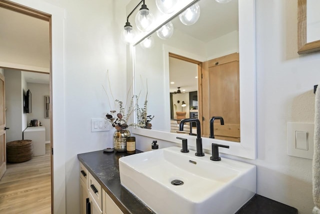 bathroom with vanity and wood finished floors