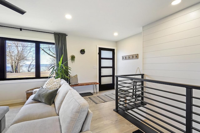 living room featuring recessed lighting, light wood-type flooring, and baseboards