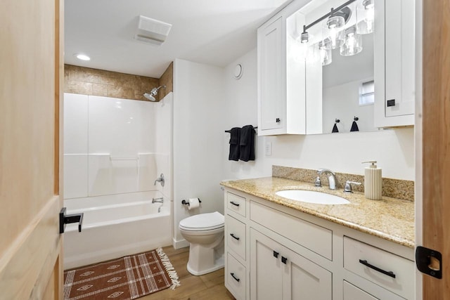 full bathroom with toilet, wood finished floors, vanity, and shower / tub combination