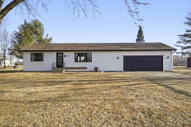 ranch-style house with a garage and concrete driveway