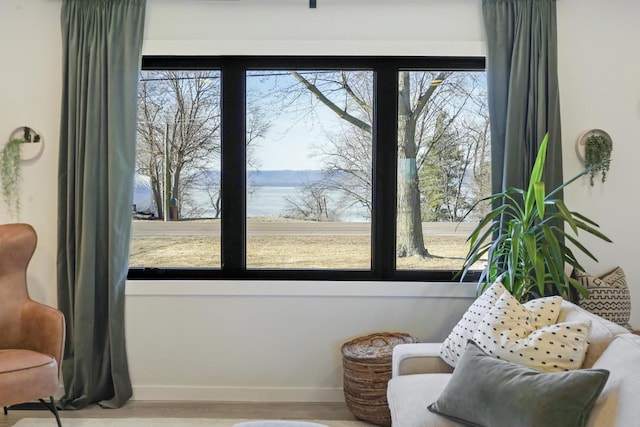 sitting room with a wealth of natural light and baseboards