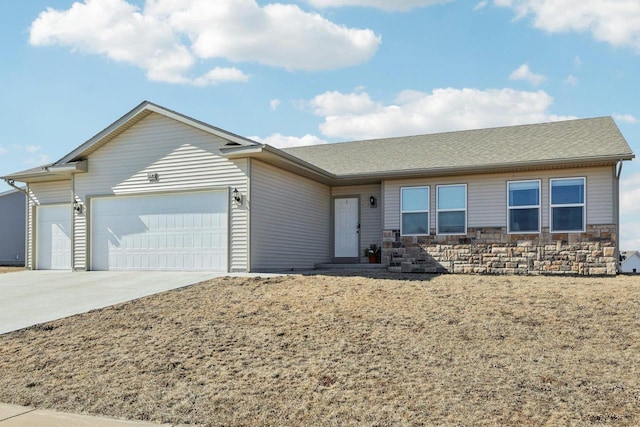 ranch-style home with concrete driveway, a garage, and stone siding