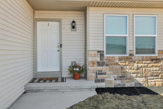 property entrance with stone siding