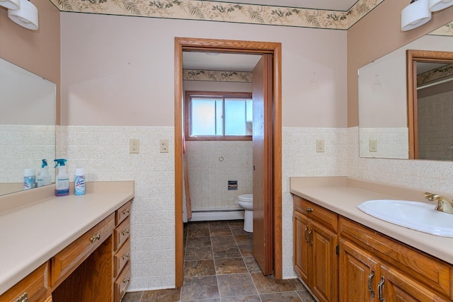 full bathroom with tile walls, a wainscoted wall, toilet, and vanity