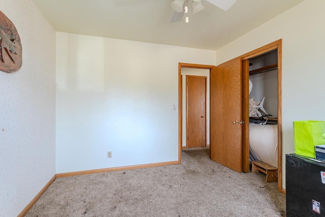 unfurnished bedroom featuring baseboards, ceiling fan, and carpet flooring