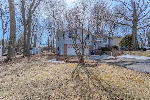 exterior space featuring brick siding, an attached garage, a storage shed, and an outdoor structure