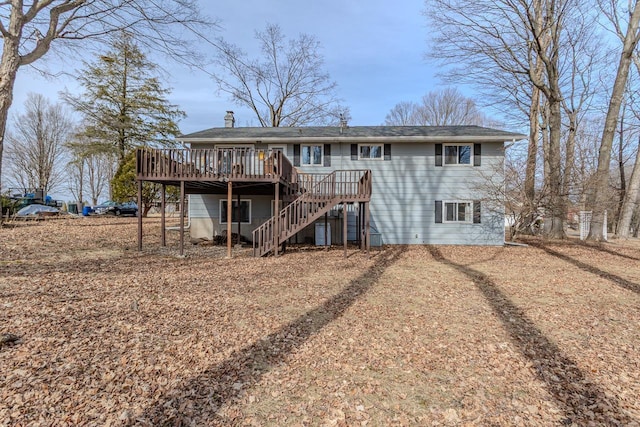 back of property with stairway, a chimney, and a deck