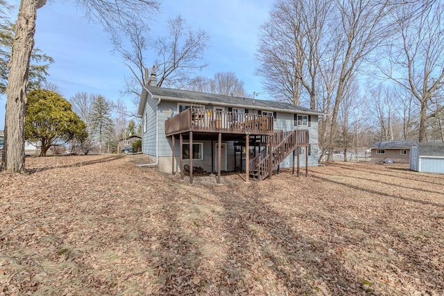 rear view of property featuring a deck and stairs