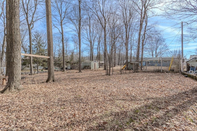 view of yard with a storage unit and an outbuilding