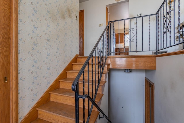 stairway with wallpapered walls