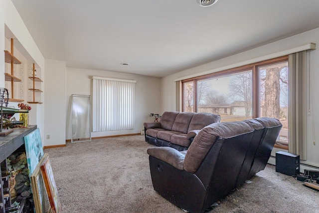 living room featuring baseboards, plenty of natural light, and carpet flooring