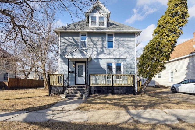 american foursquare style home with a wooden deck and fence