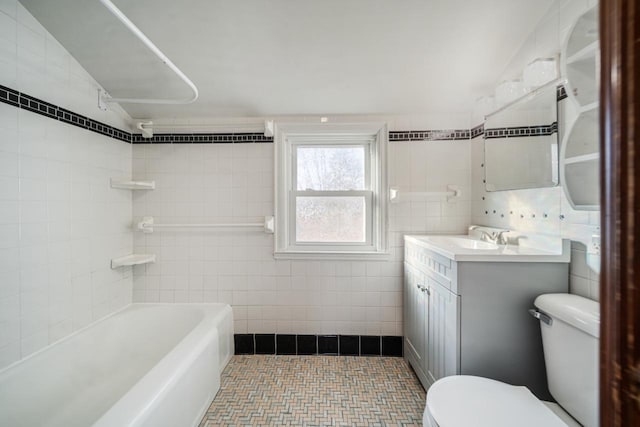 full bath with vanity, toilet, and tile walls