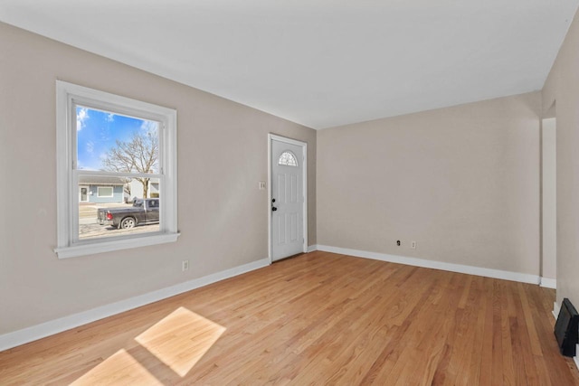 entryway featuring baseboards and wood finished floors