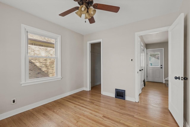 unfurnished bedroom with light wood-style flooring, visible vents, baseboards, and a closet