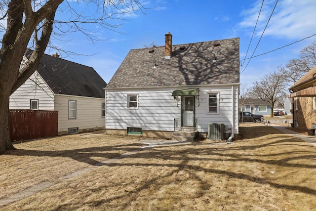 back of house with cooling unit, fence, roof with shingles, a chimney, and entry steps