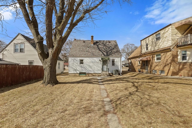 rear view of property with cooling unit, fence, and entry steps