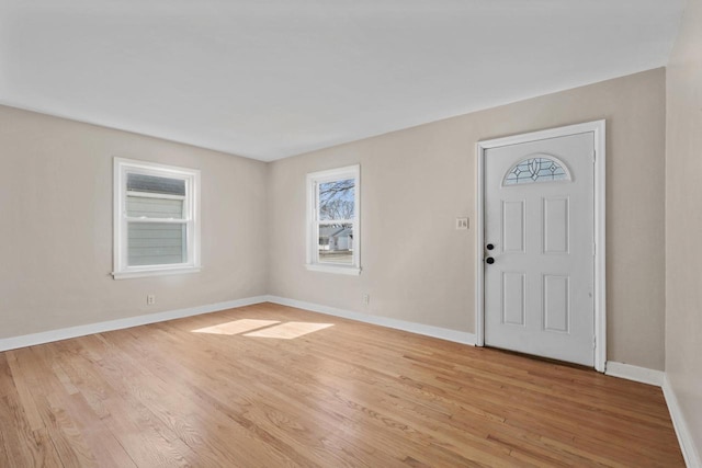 entryway featuring baseboards and light wood-style floors