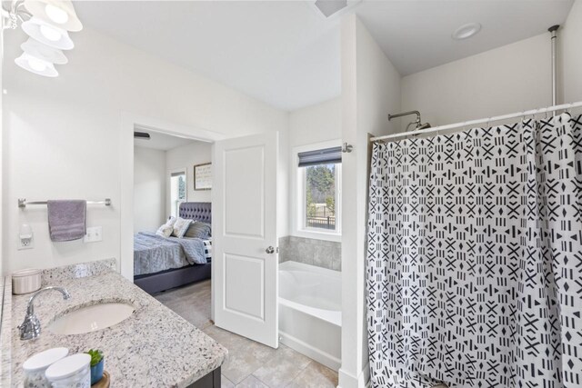 full bath with a bath, plenty of natural light, tiled shower, and vanity