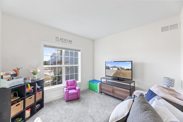 living room with visible vents, baseboards, and carpet