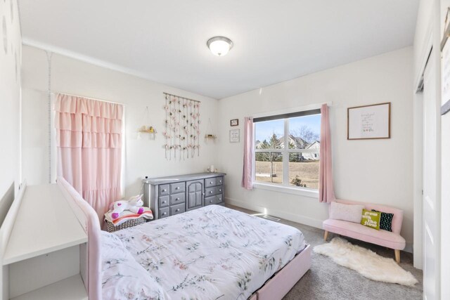 carpeted bedroom featuring baseboards